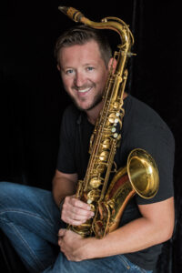 Photo of Paul Booth holding a saxaphone