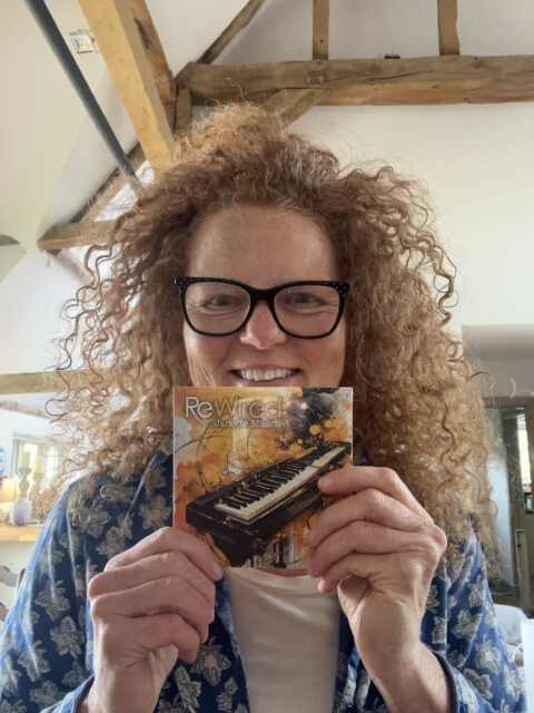 Janette Mason holding ReWired CD